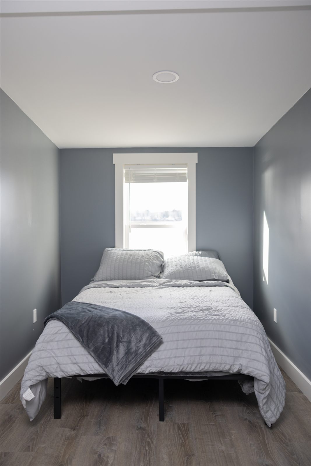Bedroom with gray walls and white bedding