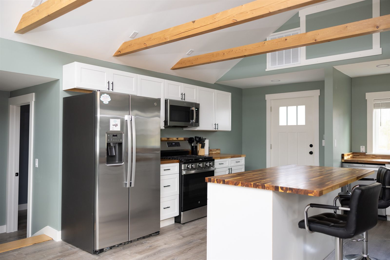 Modern kitchen with wood island and white cabinets